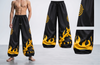 Black pants with yellow flame patterns worn by a model, with additional views of the pants on a gray background.